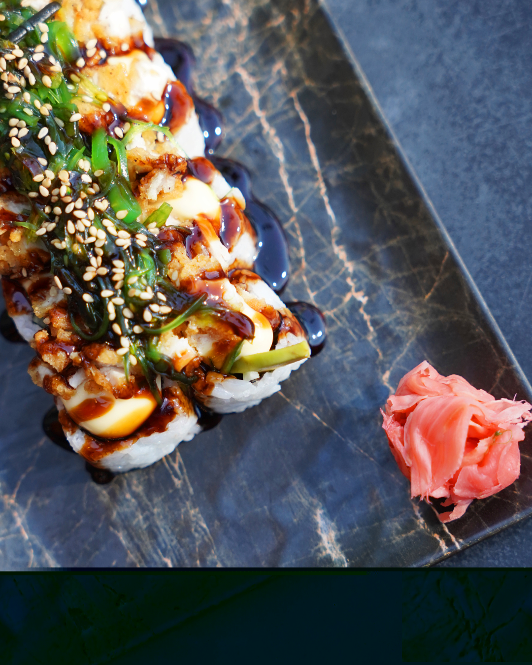 Sushi roll with seaweed salad, sesame and teriyaki glaze